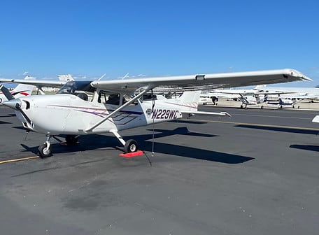 Cessna 172 G1000 N229WC on the ramp under a clear blue sky